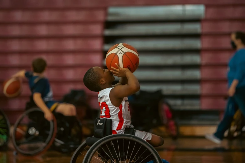 a young person in a wheel chair with a basketball