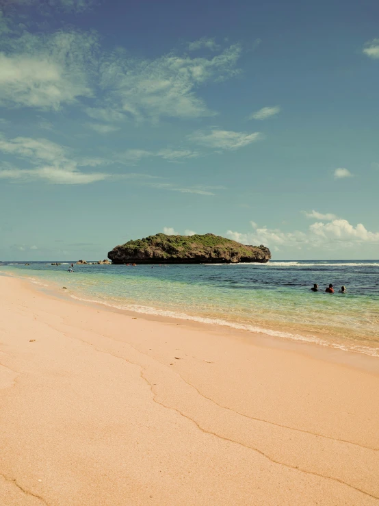 people sit on the beach at low tide