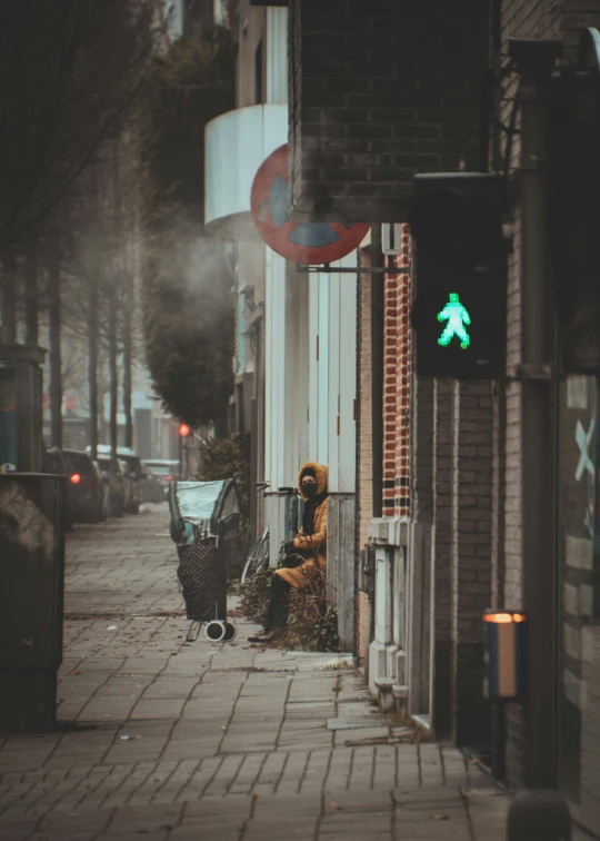 a person sitting in a chair on a city street at night