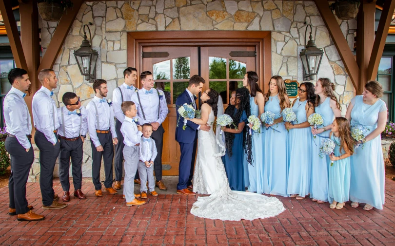 a wedding party in front of the doors of a el