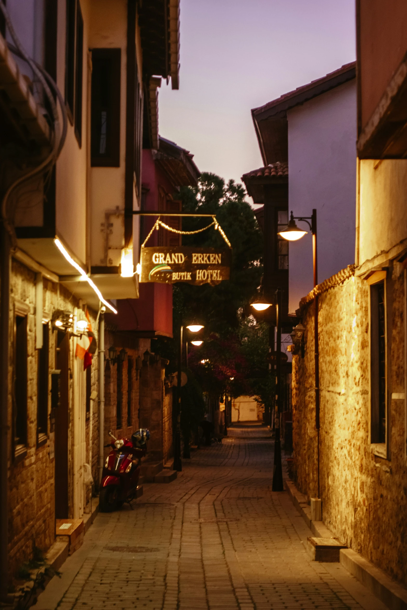 a street at dusk with some light up