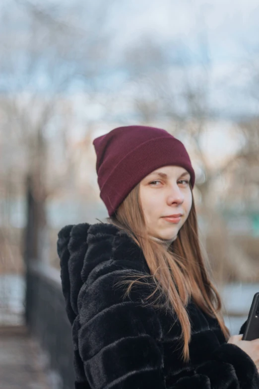 woman in the winter looking at her cellphone