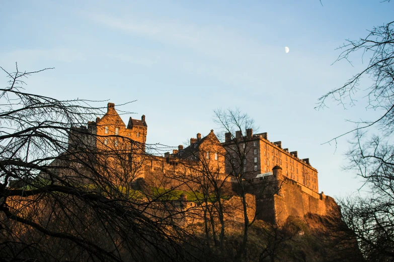 an old castle sitting above the trees