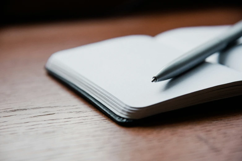 a pen on top of an open notebook