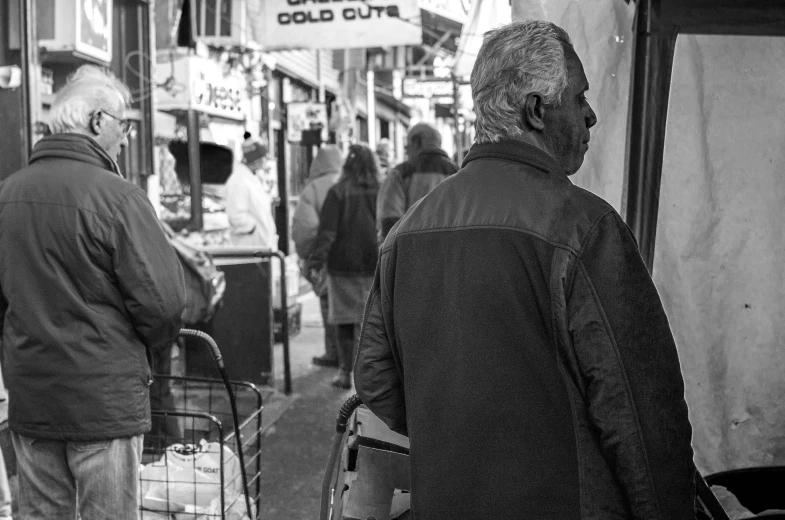 two men are looking at the vendors at a market