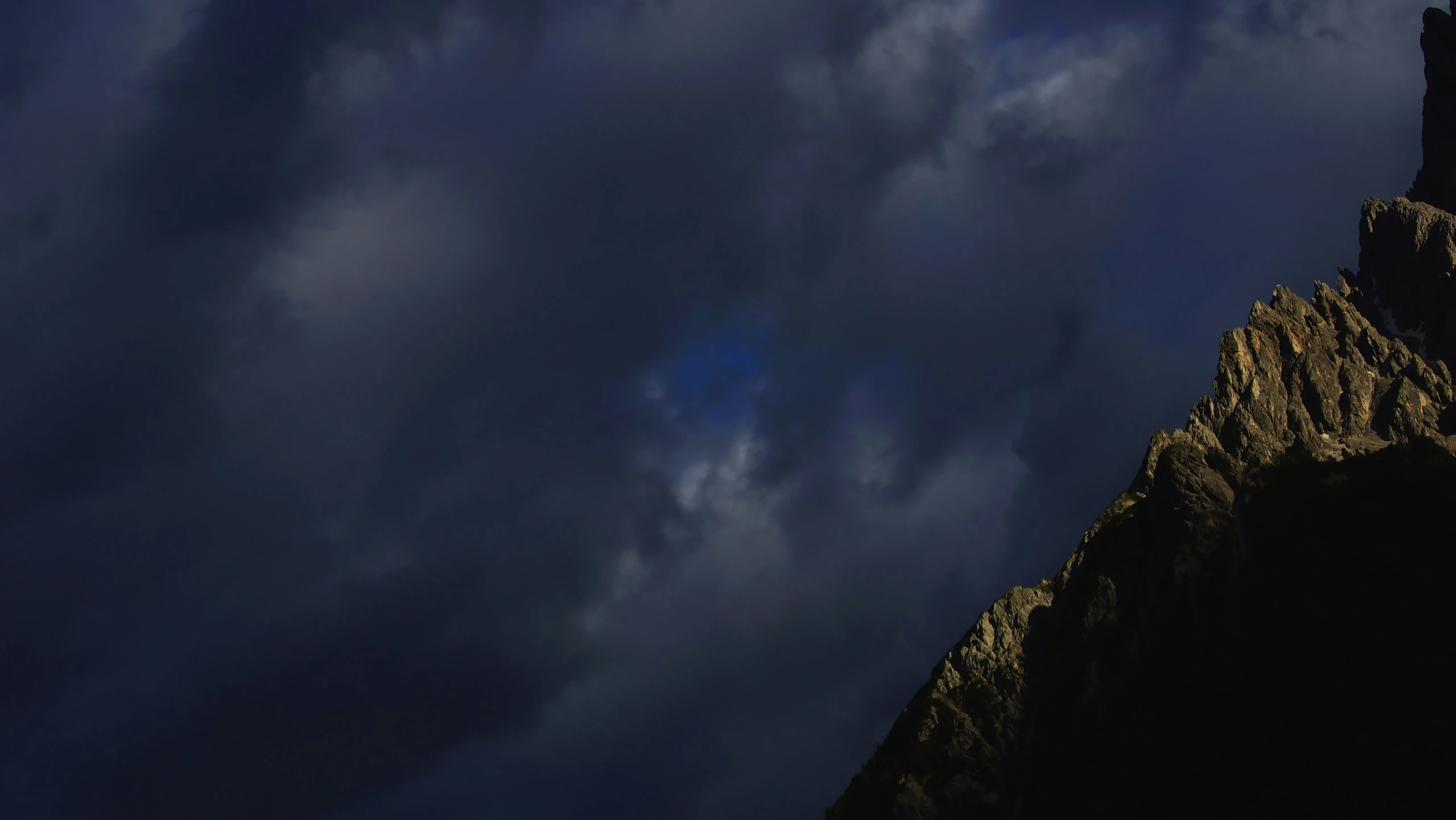 a steep cliff with a clock tower on it at night