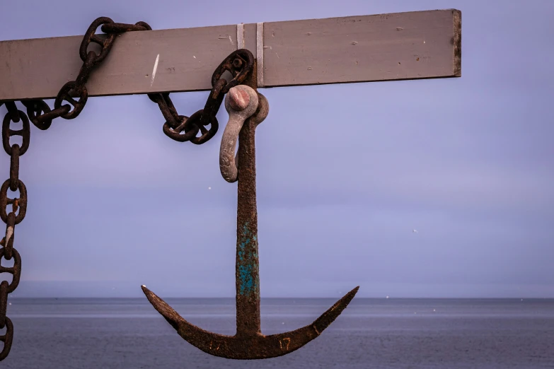 an anchor hangs over a boat in the water