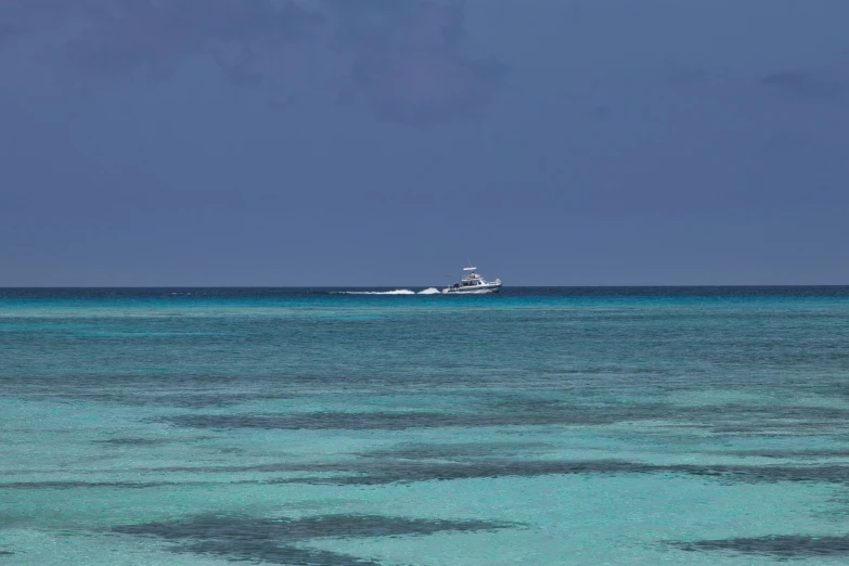 there is a ship floating in the blue water