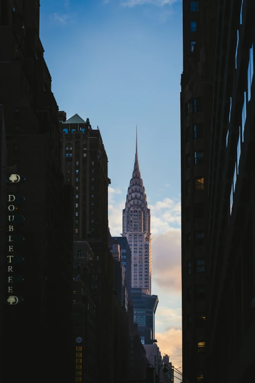 the chrysler building towering over the city at twilight