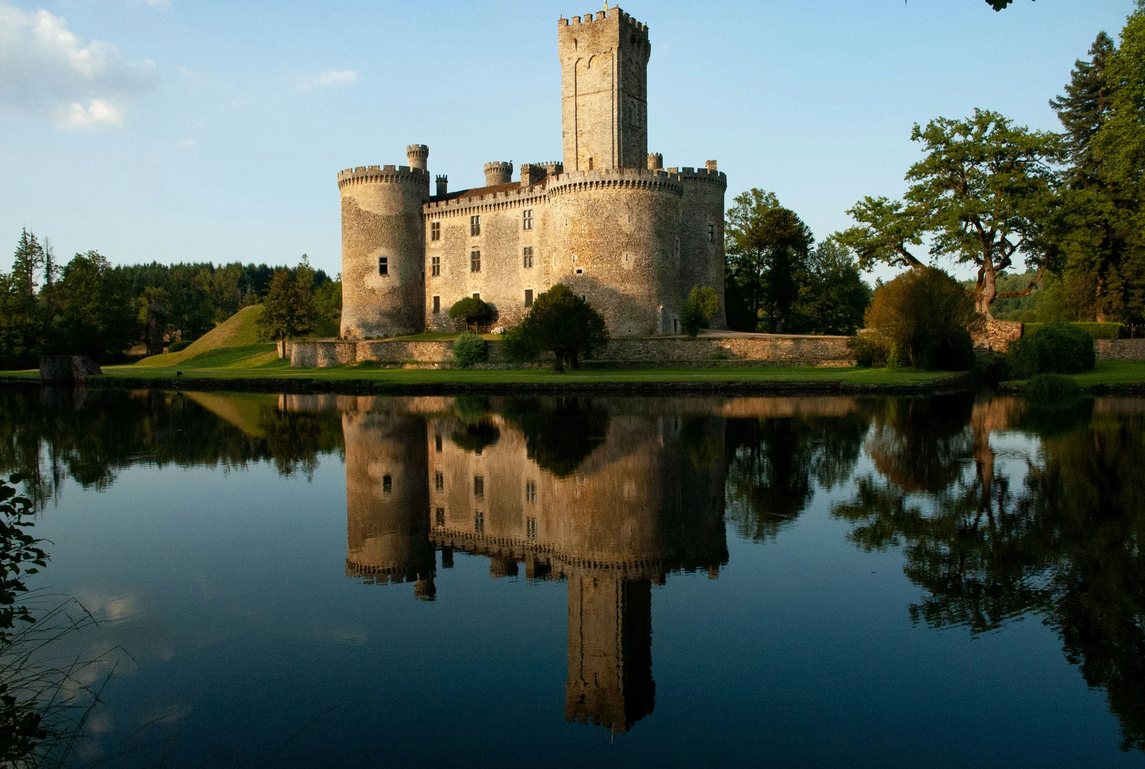 an old castle with water in front of it