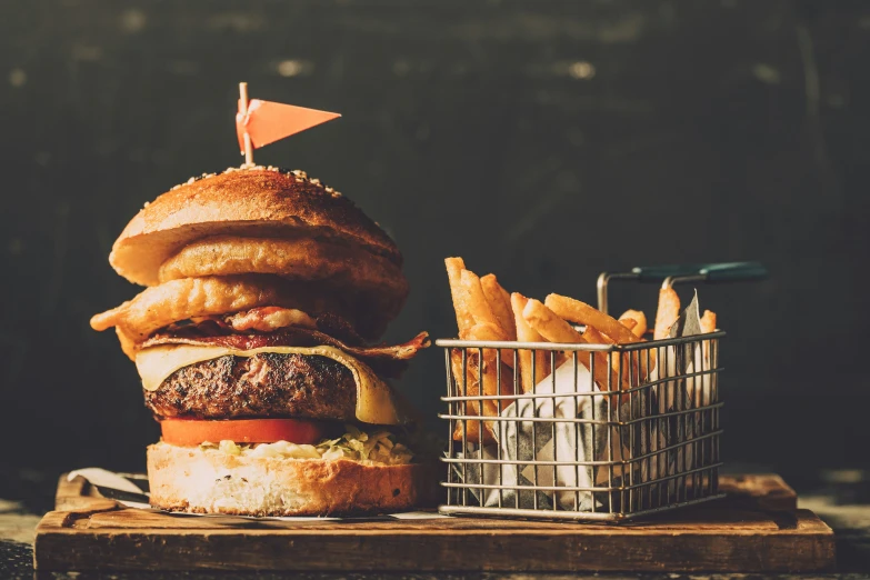 a hamburger with fries in a basket on the table