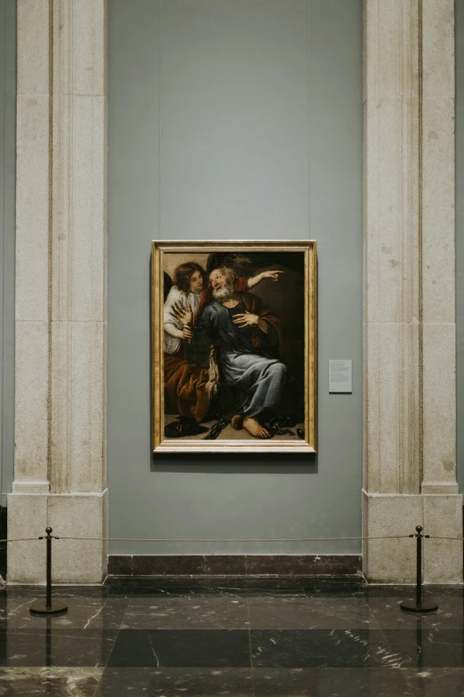 a painting hangs in the middle of a museum
