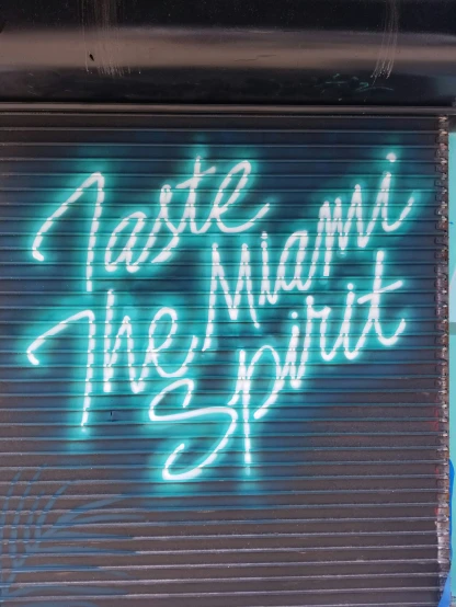 a garage door with writing on it that reads paste miami the spirit