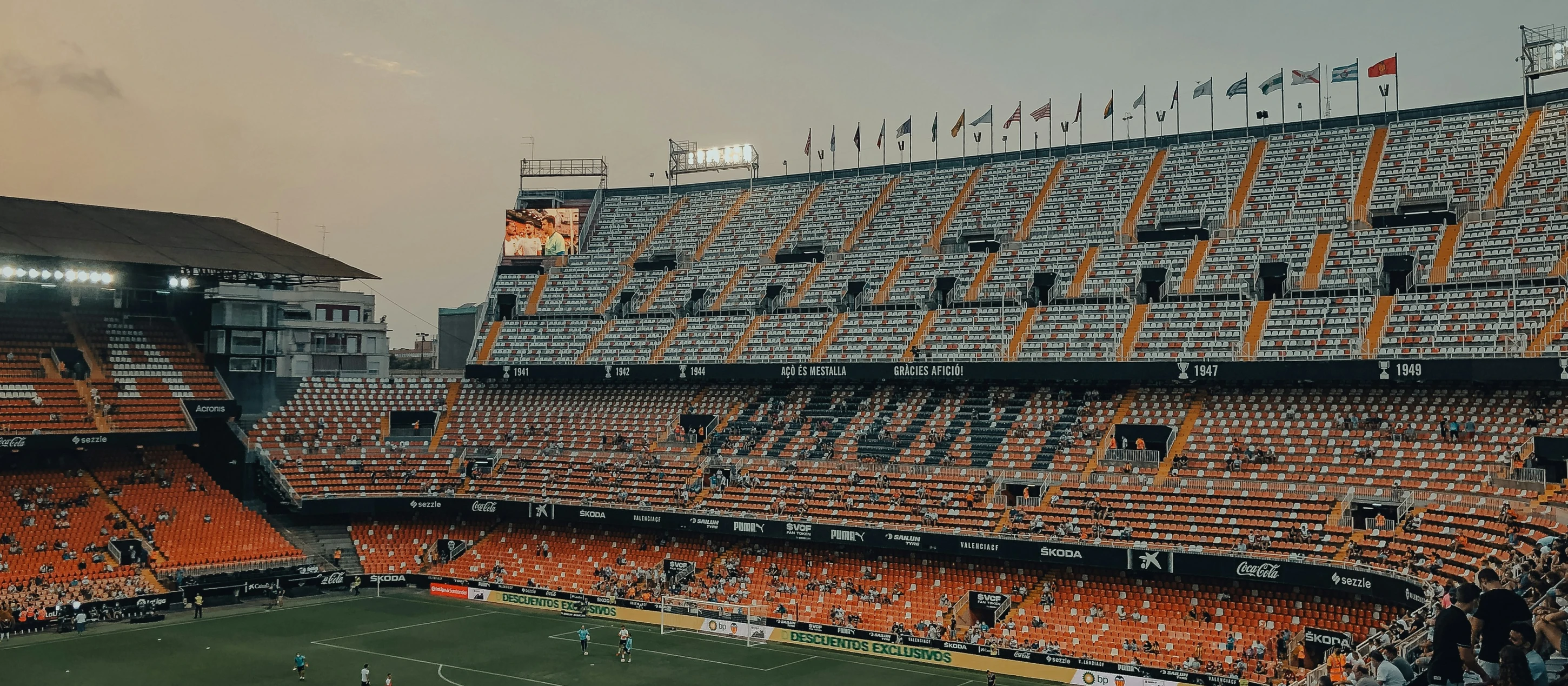 an orange stadium full of people during the day