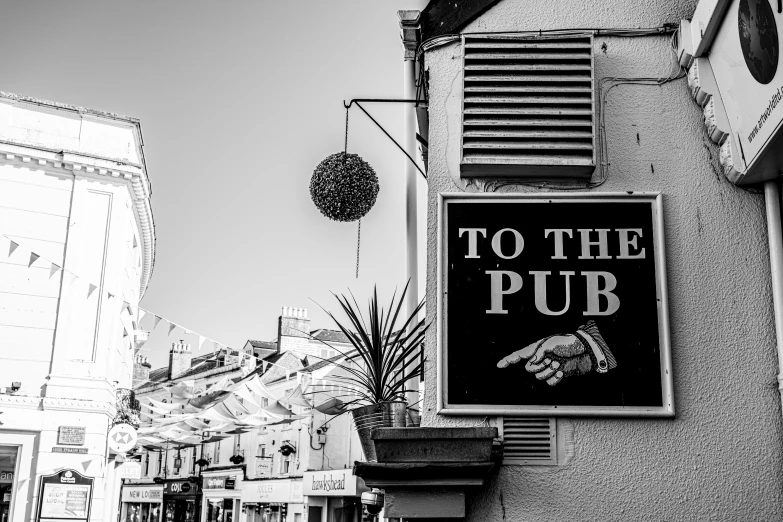 a sign that reads to the pub next to an old building