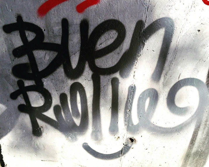 a graffiti on a wall reads, sell revolution