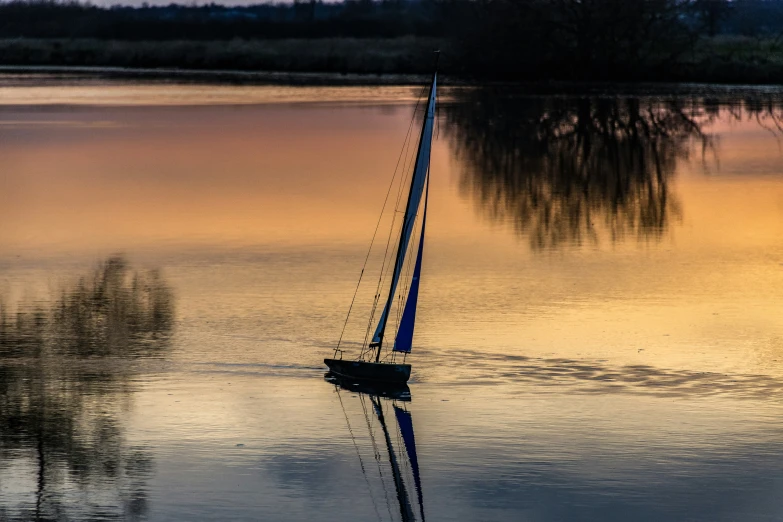 a boat floating on the river at sunset