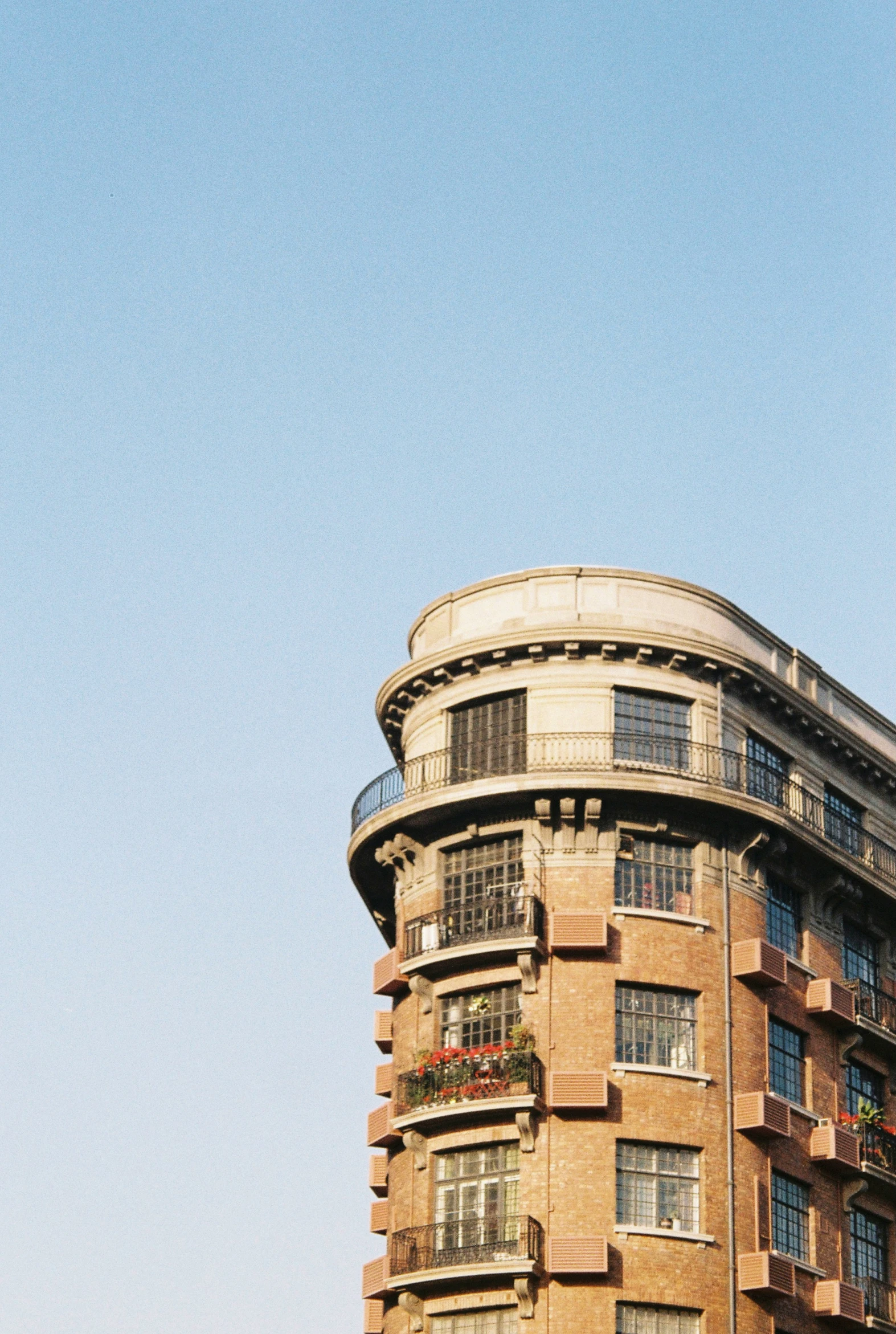 an apartment building that has balconies on its top