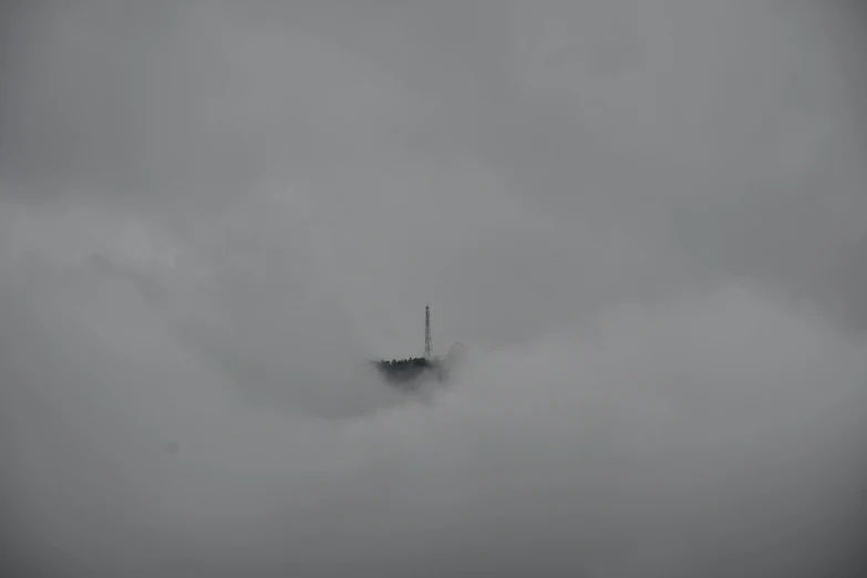 there is a lighthouse that is in the fog