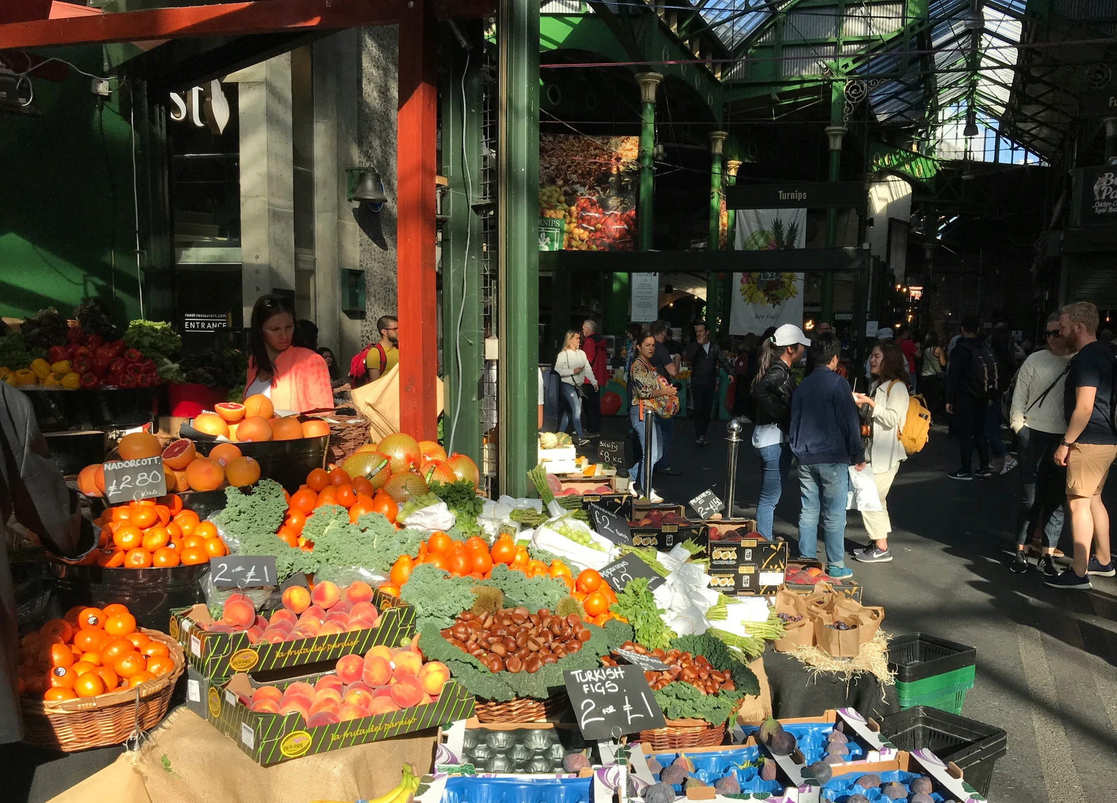 a market with various fruits and vegetables displayed on tables