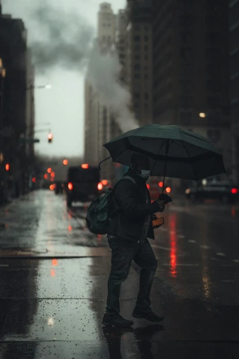 a man standing on the side of a road under an umbrella