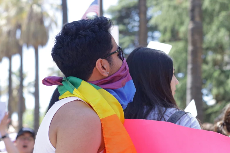 a man and woman stand together near each other in front of a crowd