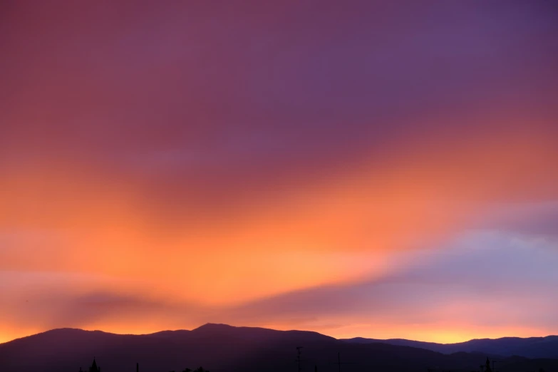 a sunset with dark clouds in the sky