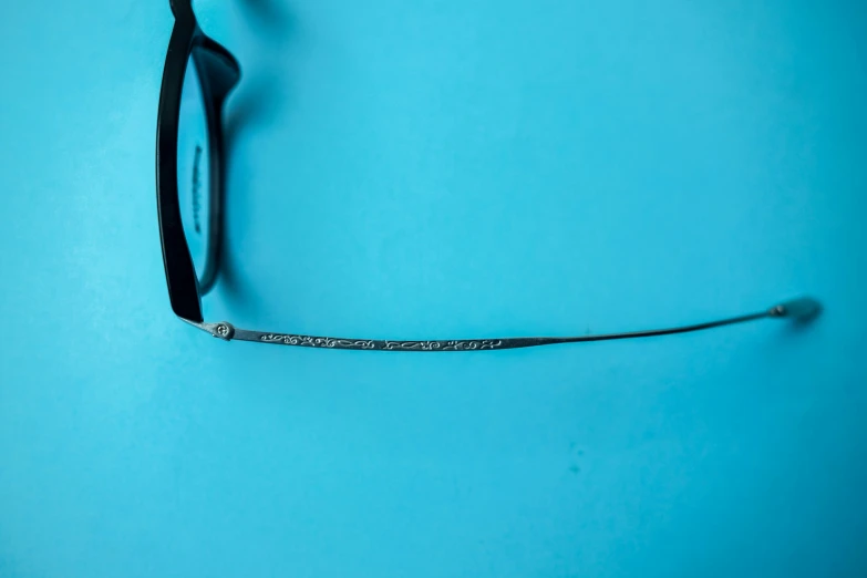 some kind of metal wire is laying on the blue surface