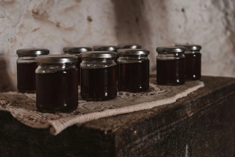 five jars of jelly sitting on top of a table