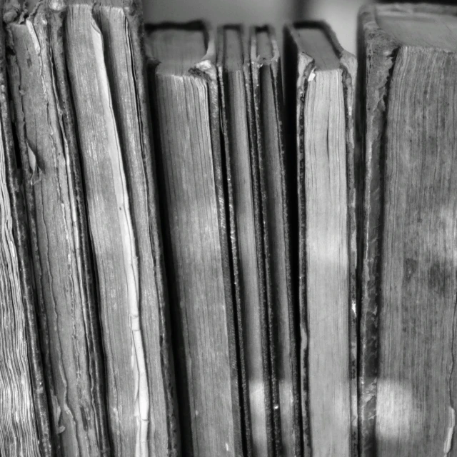 black and white po of book stacks with one opened