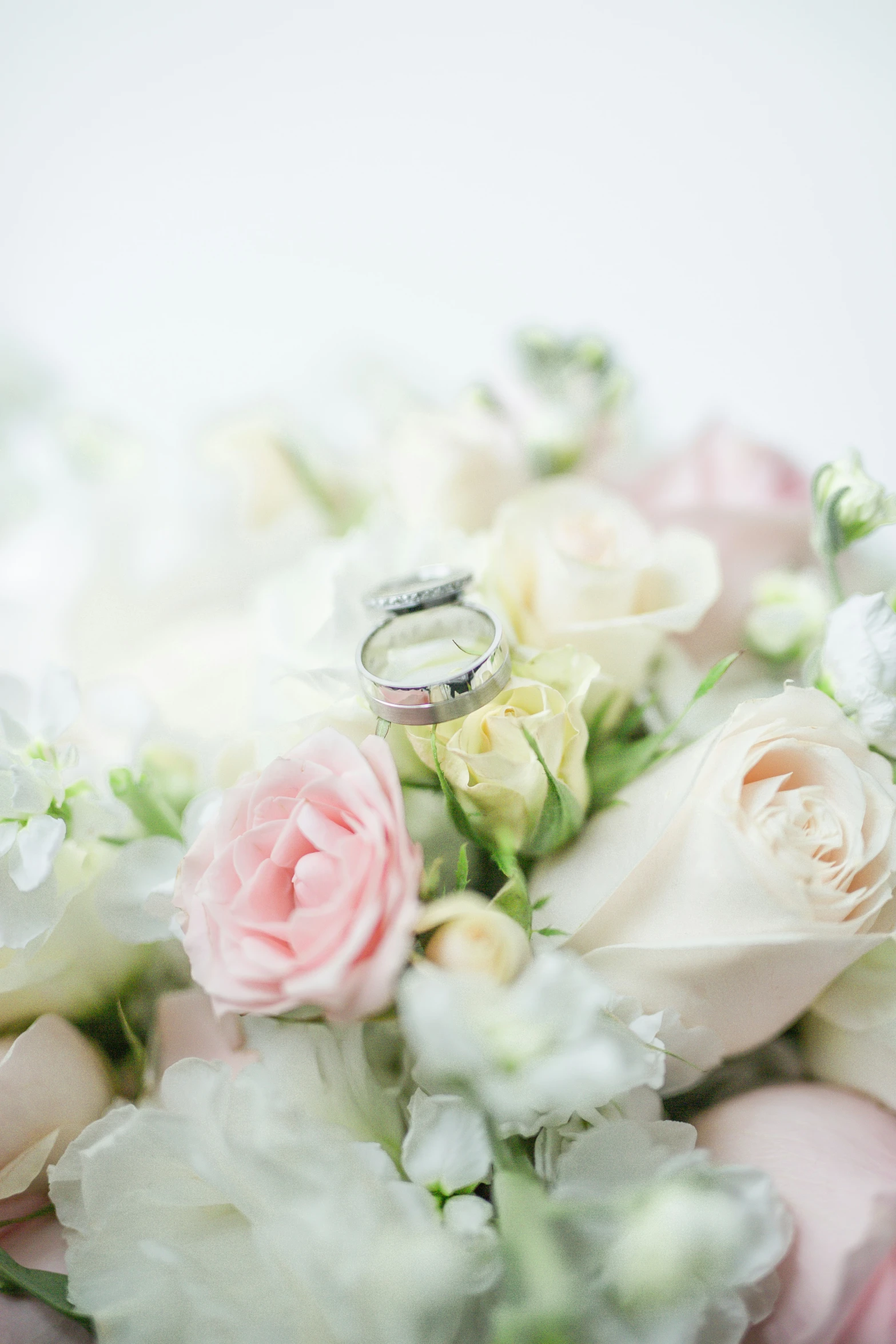 wedding rings with flowers on top of it