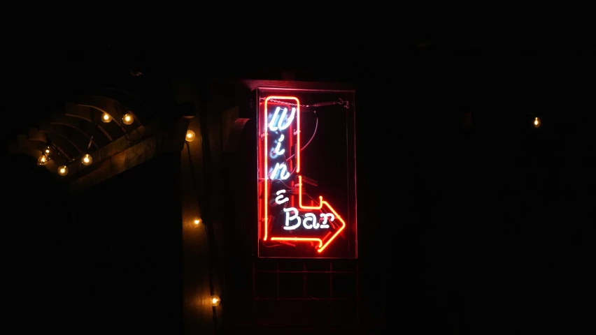 a close up of a neon sign that reads, let's go bar