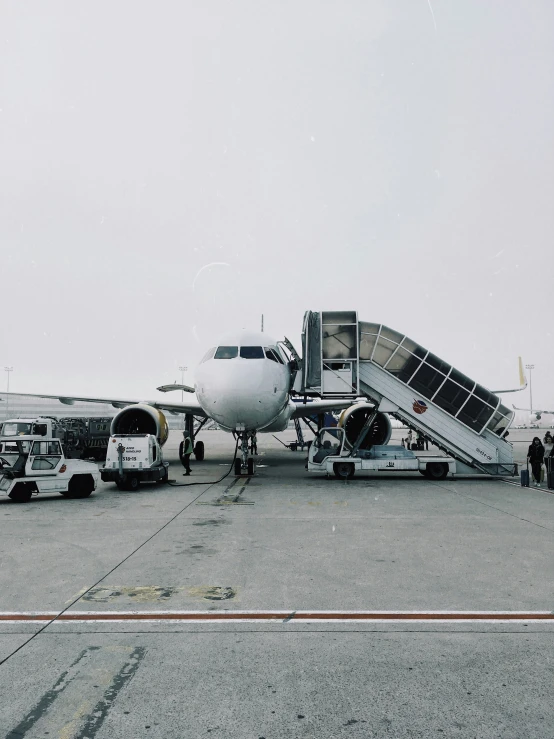 an airplane being unloaded and parked on the tarmac