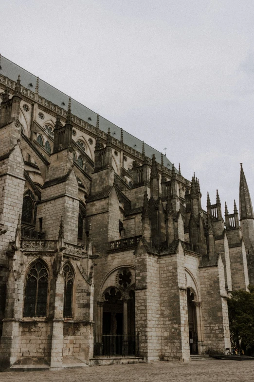 the large cathedral is next to some large brick buildings