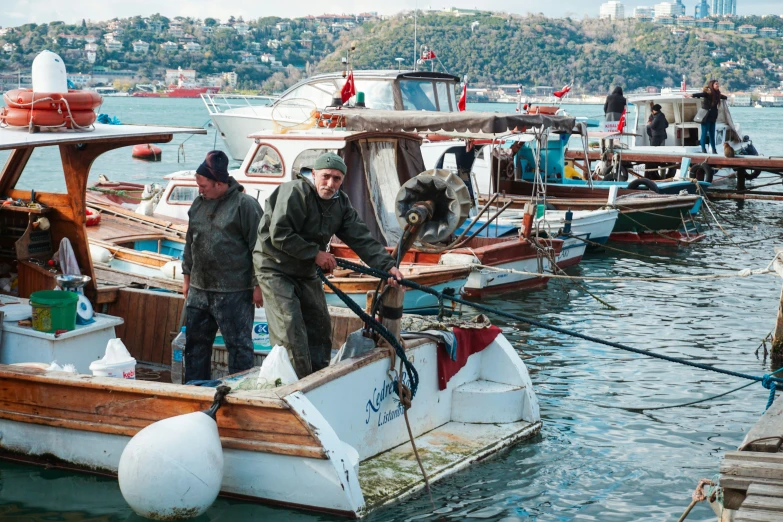 the men are standing at the boat dock