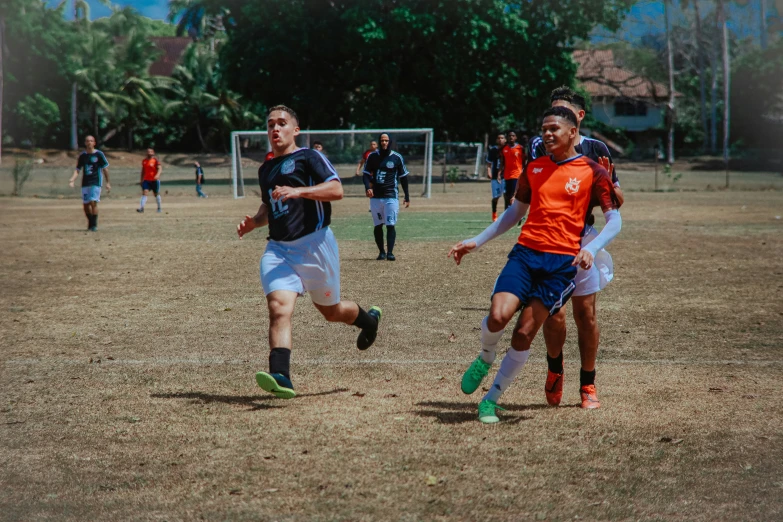 two teams playing a soccer game in the park