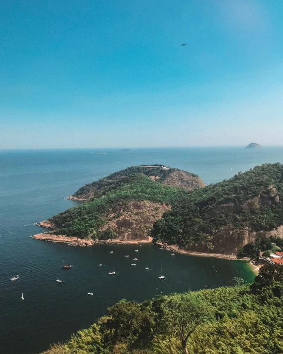 a beautiful view of a bay surrounded by green hills