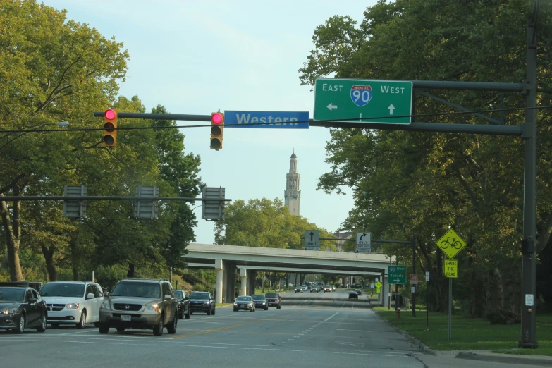 a street sign and cars at an intersection with traffic lights