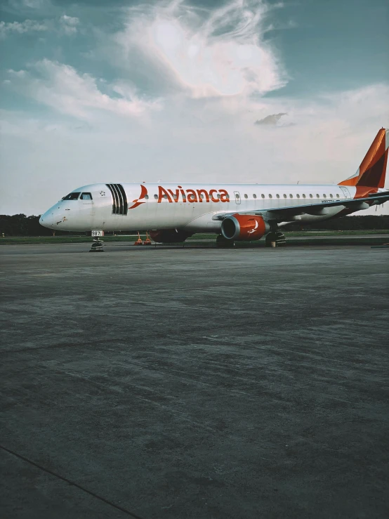 a passenger jet parked on the tarmac at the airport