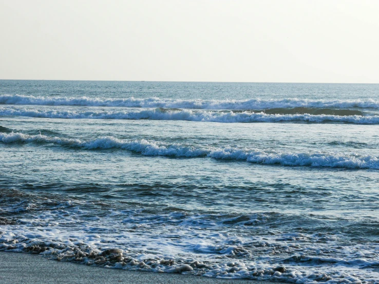 ocean waves rolling in and out onto the sand