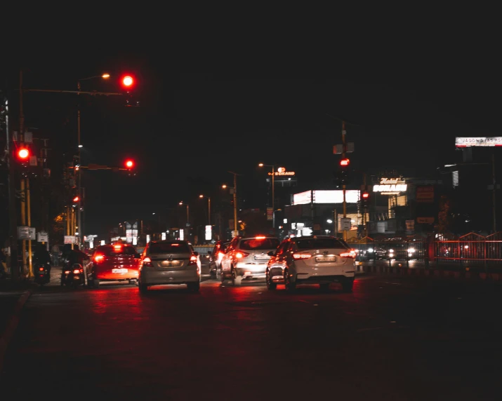 a busy street filled with lots of traffic at night