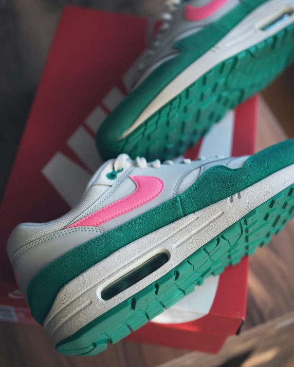 the green and pink air max shoes are being displayed