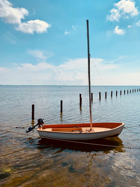 a boat on the water is near some poles