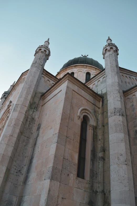 an old church with two steeples and two arches