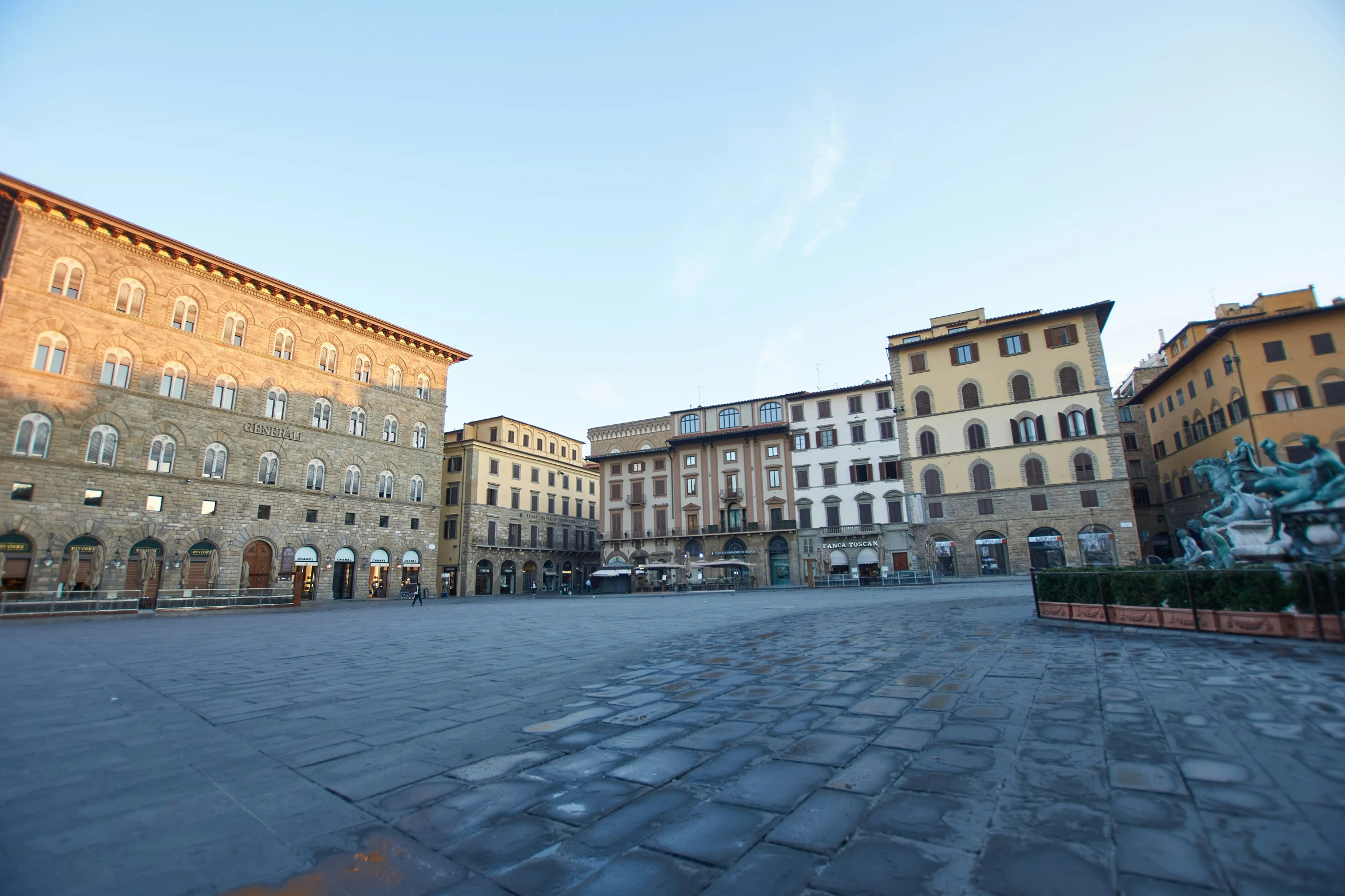 several buildings with a cobblestone surface in the middle of it