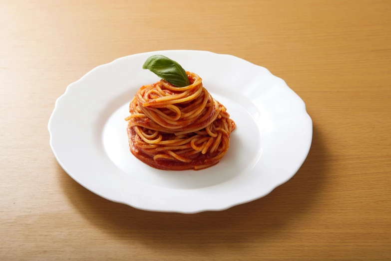 a close up of a plate with spaghetti on it