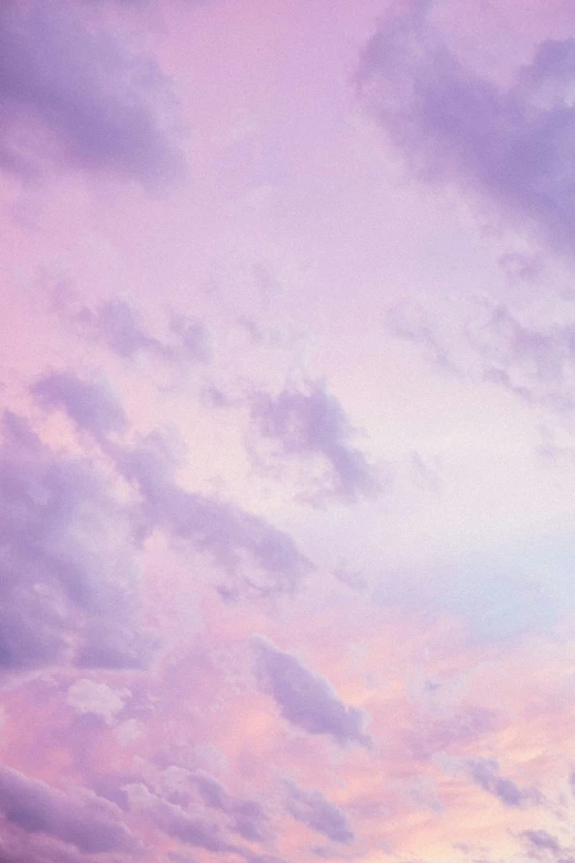 the sky is covered with clouds in a purple hue