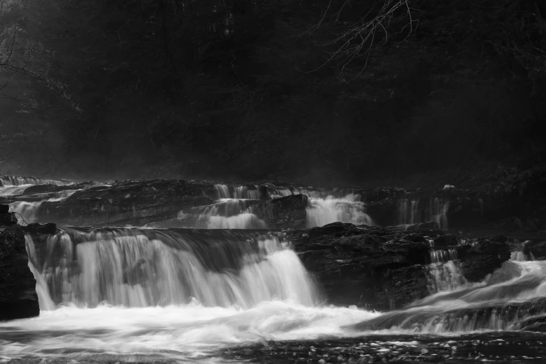 water pours into the water between several rock formations