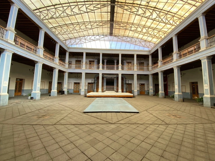 an empty courtyard with a light colored ceiling and blue walls