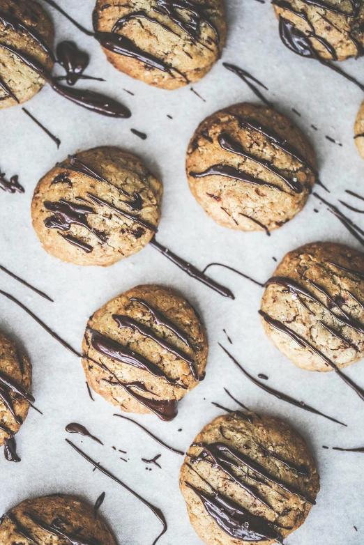 chocolate - covered cookies with melted on top sitting on a baking sheet